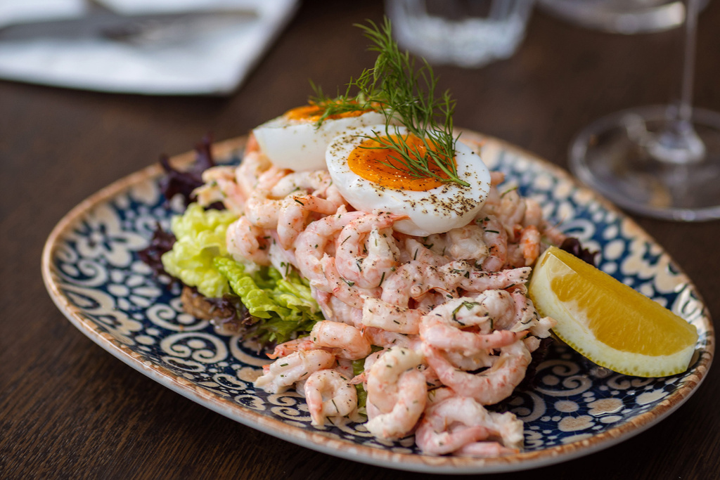 The Skagen at Phoenix - a classic dish, served on sourdough bread, with iceberg lettuce, shrimp salad and a soft-boiled egg. Can be made gluten-free.